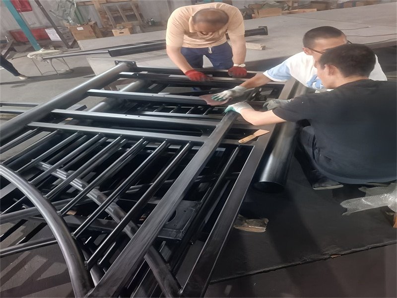 Horse stable manufacturing process with workers assembling components