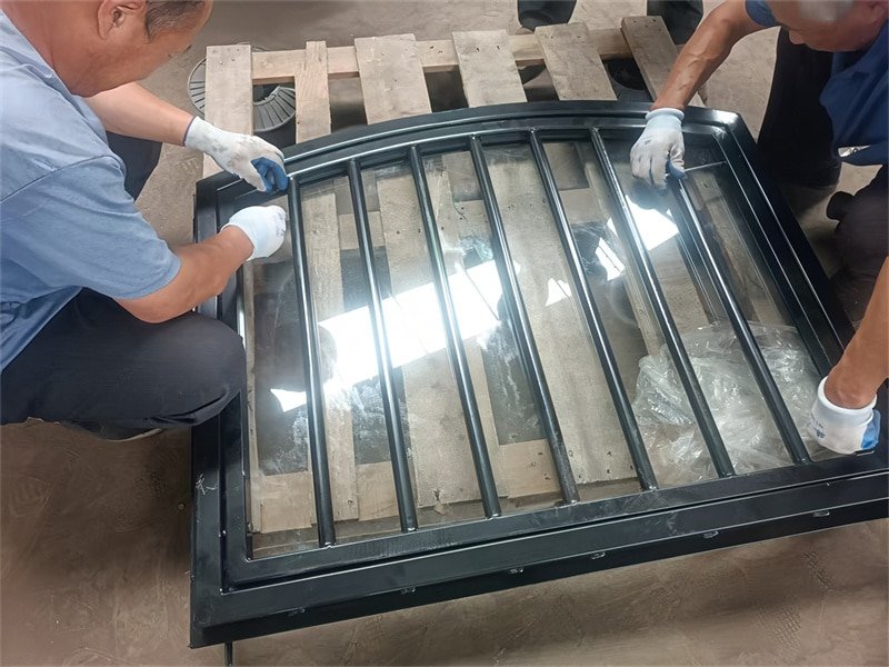 Workers assembling a durable horse stable in a factory setting
