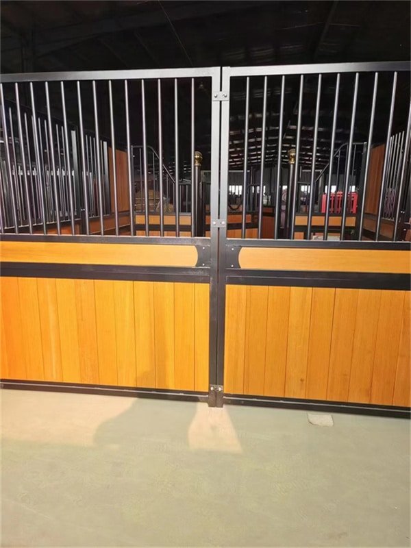 Workers constructing a robust horse stable structure.
