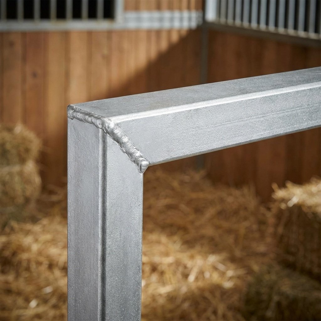 detailed product shot of a horse stall door corner, welded U-channel steel profile, hot-dip galvanized finish, silver metallic texture, no rust, professional studio lighting, horse stable context, no text, no labels, --ar 16:9 --style raw --v 6.0